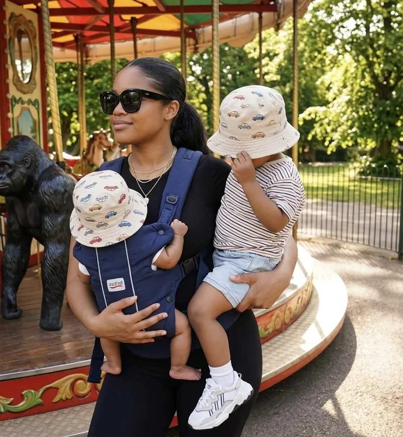 Dichaine with her two boys at the carousel